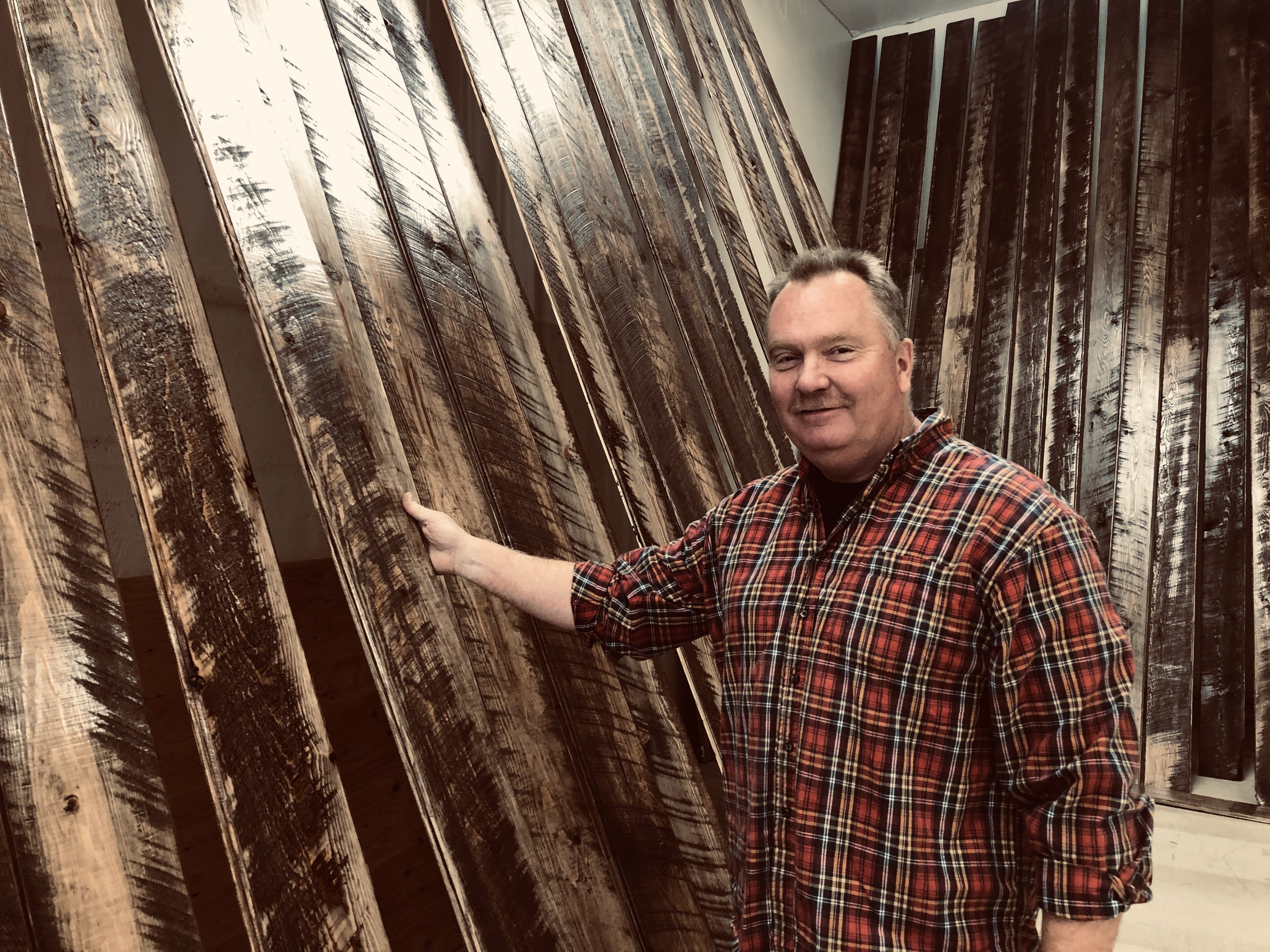 IMG_1288 Lyle Larson stands in front of lumber he has milled himself, and which he will be using in the new store.